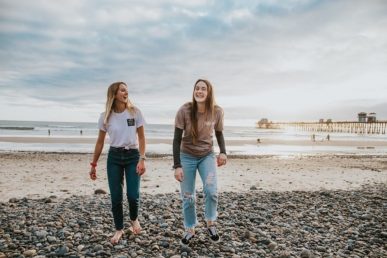 Two smiling women at the beach